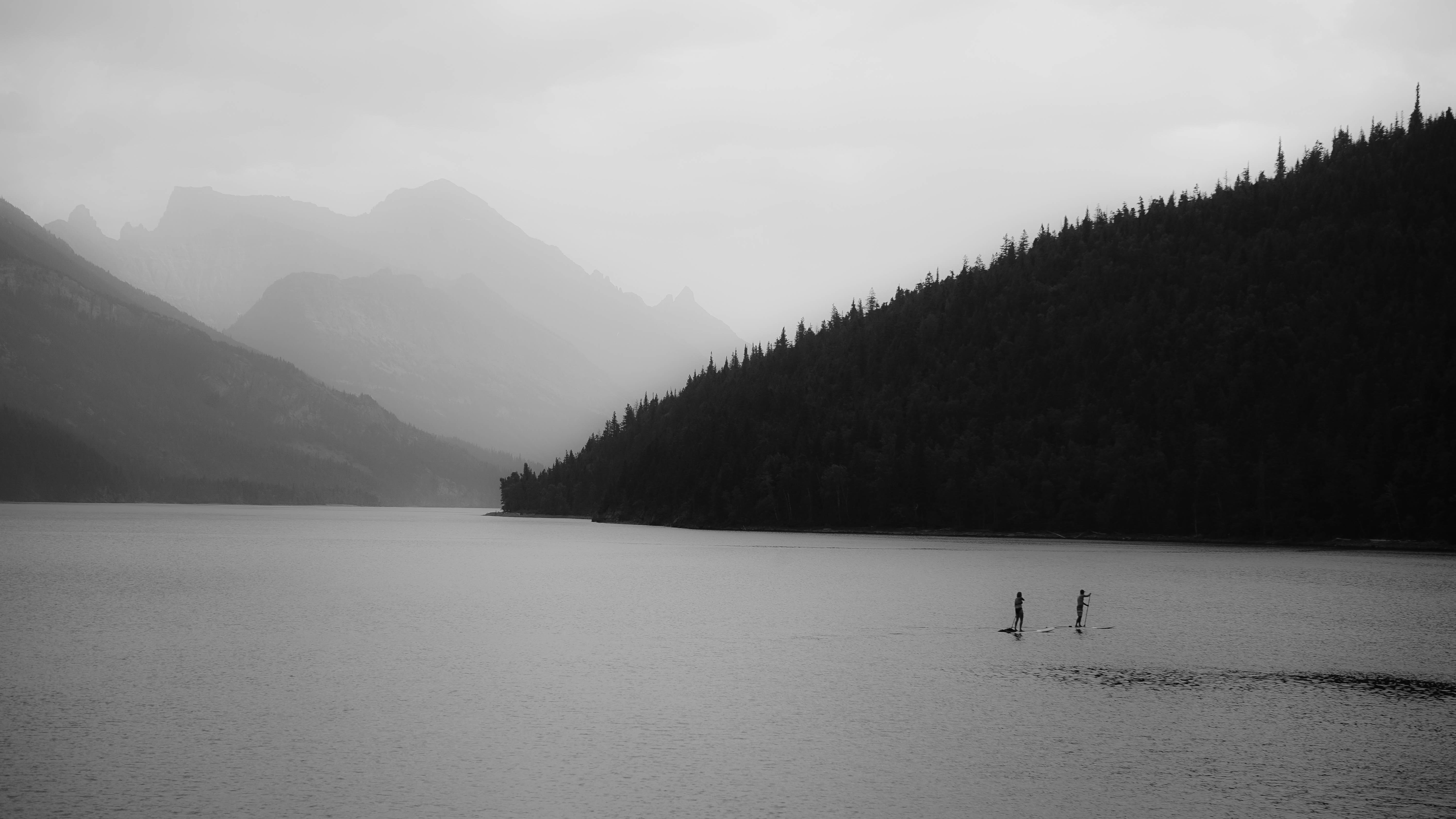 silhouette of hills near body of water at daytime